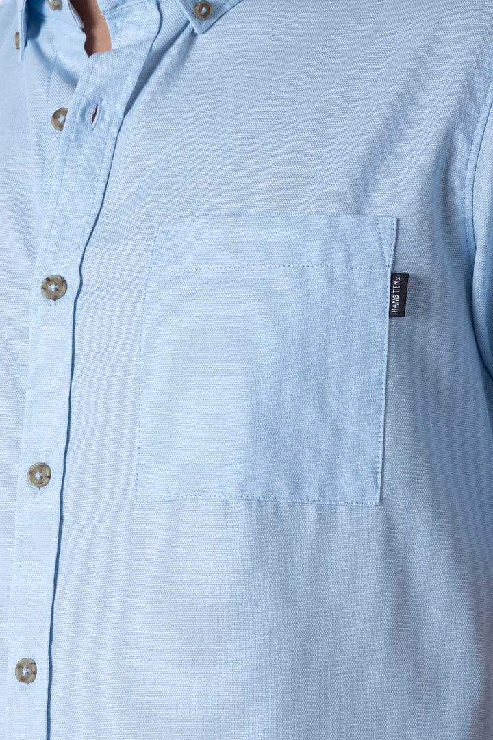 Camisa azul claro manga corta con bolsa - Hang Ten